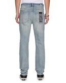 Ksubi Chitch Astral Intruder blue denim jeans with distressed details and signature stitching on a model.