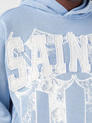 Copper Rivet Saint Patched Cropped Hoodie In Light Blue