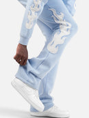 Copper Rivet Saint Patched Stacked Sweats In Light Blue