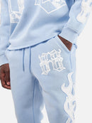 Copper Rivet Saint Patched Stacked Sweats In Light Blue