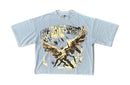 A light blue short-sleeve graphic t-shirt featuring the band name 'SILENT VERSE' in distressed lettering above a winged figure illustration, laid flat against a white background. By Fresh N Fitted.