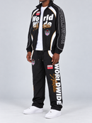 Men's black Copper Rivet 'World Wide' windbreaker sweatpants with rivet details, shown from an angled side view.