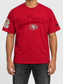 Red Pro Standard San Francisco 49ers drop shoulder T-shirt featuring team logo and "Living Large" design on front.