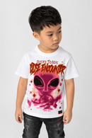 A young boy wearing a white t-shirt with a pink alien graphic and 'Secret Code: Close Encounter' text, paired with dark jeans, against a light gray background.