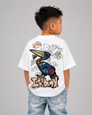 A child wearing a white short-sleeve t-shirt with a colorful toucan graphic and graffiti-style text, paired with light blue jeans, shown from the back against a solid gray background.