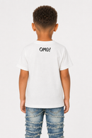 A child model shown from the back wearing a white short-sleeve t-shirt with the text 'OMG!' printed in black across the upper back, paired with distressed blue jeans, against a plain light gray background.