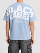 Black Label Premium T-Shirt in light blue, casual fit, soft fabric, with a classic crew neckline, displayed on a hanger.