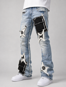 Light wash blue denim jeans with distressed details, featuring large black and white star-shaped patch designs on the thighs and lower legs, styled with a white t-shirt and white sneakers.