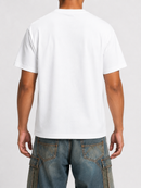 A man viewed from the back wearing a plain white short-sleeve crewneck t-shirt and blue denim cargo pants against a light gray studio background.
