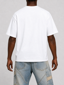 A man viewed from the back wearing a plain white short-sleeve t-shirt and light blue distressed denim jeans, set against a neutral gray studio background.