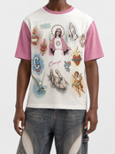 A model wearing a short-sleeve t-shirt with pink raglan sleeves and a white body, featuring a detailed graphic print of religious icons, saints, and hands. The model is also wearing distressed blue jeans.