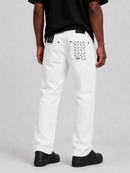 White denim jeans with a black and white patterned back pocket, shown on a model from the back against a light gray studio background.