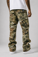 Rear view of a person wearing camouflage cargo pants with a white t-shirt and white sneakers, photographed against a light gray studio background.