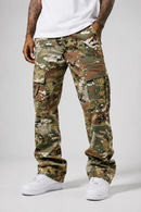 A person wearing camouflage cargo pants with a white t-shirt and white sneakers, shown from the waist down against a light gray studio background.