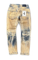 Distressed acid-wash jeans shown from the back, featuring a faded tan and blue colorway with heavy distressing and a white size label in the back pocket. By Fresh N Fitted.