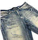 Close-up of distressed blue denim jeans with heavy fading and ripped details, shown on a plain white background. by fresh n fitted.