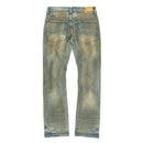 A pair of faded antique wash denim jeans shown from the back, featuring a distressed wash with light brownish-beige discoloration and small white paint splatter details. By fresh n fitted.