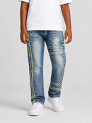 A person wearing blue denim jeans with decorative yellow stitched details down the sides and distressed patches near the lower legs, paired with a white t-shirt and white sneakers, against a light gray studio background.