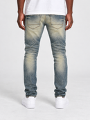 Jordan Craig Sean 'Alkaline' fit denim jeans with shredded details in desert color, showcasing distressed denim style.