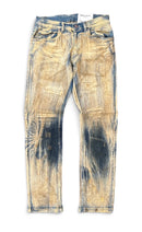 Distressed acid-wash jeans featuring a faded tan and blue colorway with heavy distressing. By Fresh N Fitted.