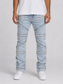 Light wash blue denim jeans with diagonal stitched frayed fabric panels, shown on a model wearing a white t-shirt and white sneakers against a light gray background.