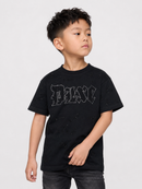 A young boy wearing a black distressed t-shirt with a rhinestone-embellished 'BAIC' logo on the chest, paired with dark gray jeans, photographed against a light gray studio background.