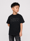 A young boy wearing a black distressed t-shirt with a rhinestone-embellished 'BASE' logo on the chest, paired with dark gray jeans, photographed against a light gray studio background.