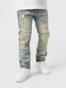 Light blue distressed denim jeans with ripped details and yellowed faded patches, shown on a model wearing white sneakers against a light gray background.