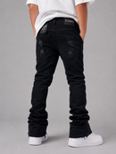 A person shown from the back wearing black FWRO jeans with distressed details, a white t-shirt, and white sneakers against a gray studio background.