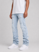 A person wearing light-wash distressed slim fit  jeans with ripped details and frayed edges, paired with a white t-shirt and white sneakers, photographed against a light gray studio background.