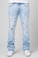 Light wash blue distressed jeans with ripped details on the thighs and knees, shown on a model from the waist down wearing white sneakers against a light gray background.