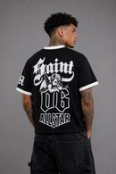 A man shown from the back wearing a black ringer t-shirt with white trim and a large white graphic print on the back reading 'Saint og Allstar'. By Fresh N Fitted