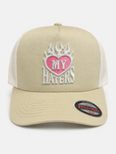 MUKA Love My Haters trucker hat in oatmeal and white with adjustable snapback and embroidered front design.