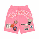 Pink shorts with various patches on a white background. by Fresh n Fitted