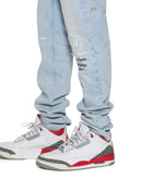 Ksubi Chitch Kstellar Effect blue denim jeans with distressed details and unique stitching on a casual model.