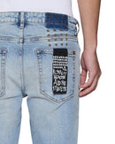 Ksubi Van Winkle Kasper blue denim jeans with classic fit and stylish design, shown on a model.