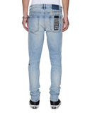 Ksubi Van Winkle Kasper blue denim jeans displayed on a model, showcasing slim fit and classic denim details.