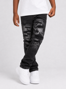 A person wearing distressed black denim jeans with faded gray wash details, paired with a white t-shirt and white sneakers, shown from the waist down on a light gray studio background.