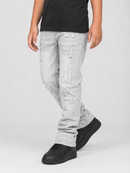 A child wearing light gray distressed denim jeans with ripped details, paired with a black t-shirt and black sneakers, shown from the waist down against a light gray studio background.
