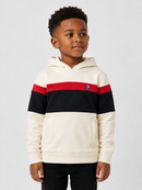 A young boy wearing a color-blocked hoodie with cream, black, and red horizontal stripes, featuring a small embroidered logo on the chest, shot against a light gray studio background.