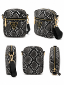 Black and white patterned crossbody bag with gold accents on a white background