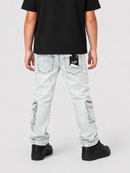 A person shown from the back wearing light-wash distressed jeans with cargo pockets, a black t-shirt, and black shoes against a light gray studio background.