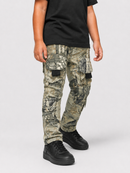 A child wearing camouflage cargo pants with black sneakers and a black t-shirt, shown from the waist down against a light gray studio background.