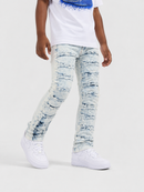 A child wearing light-wash distressed denim jeans with horizontal ripstop detailing, styled with a white graphic t-shirt and white sneakers against a plain light gray studio background.