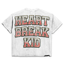 White Prestige Heart Break Kid cropped T-shirt featuring a graphic design, styled casually on a model.