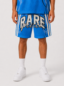 A person wearing bright blue athletic shorts with large white and black 'RARE' lettering and white side stripes, paired with white socks and white sneakers, photographed against a light gray studio background. By Fresh N Fitted.