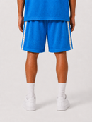 A person shown from the back wearing bright blue athletic shorts with white side stripes, a matching blue top, white socks, and white sneakers on a light gray studio background. By Fresh N Fitted.
