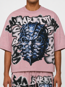 Dust pink oversized T-shirt by Rare Peace with rhinestone mask graphic, cropped fit, casual streetwear style.