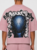 Dust pink oversized T-shirt by Rare Peace with rhinestone mask graphic, cropped fit, and relaxed style.