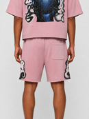 A model shown from the back wearing a pink short-sleeve t-shirt and matching pink shorts with black and white graphic prints.